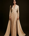 Woman wearing a beige evening gown with a long train on a dark background